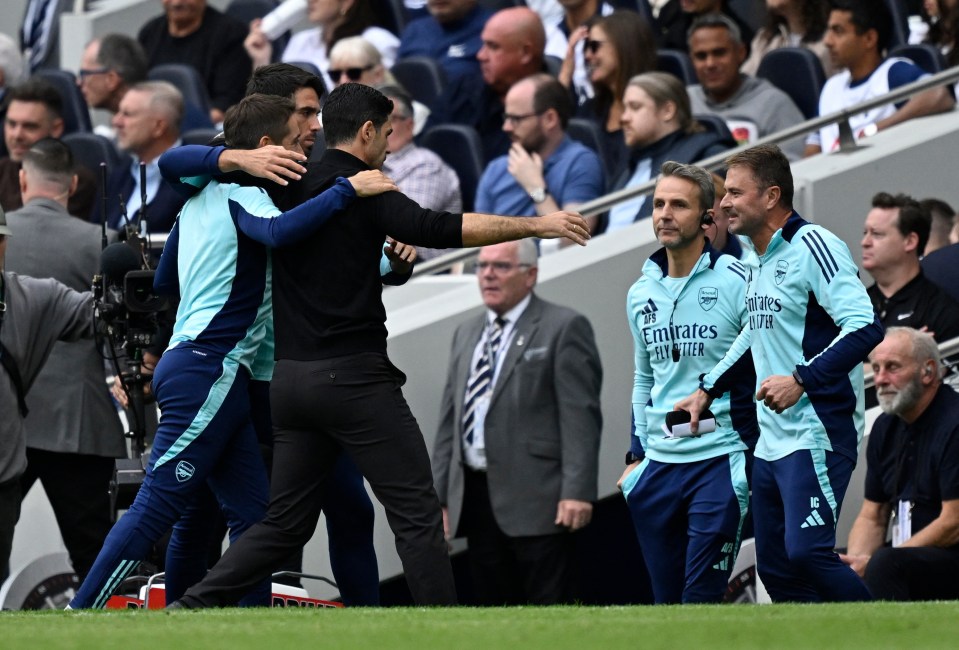 Mikel Arteta embraces his staff after the final whistle