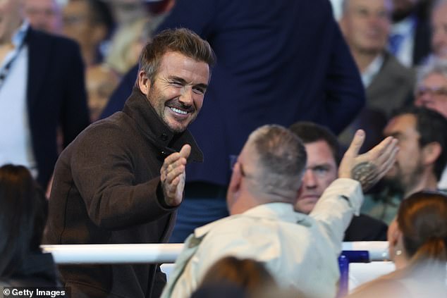 David Beckham shakes hands with fans as he joined City minority owner Brady in the stands