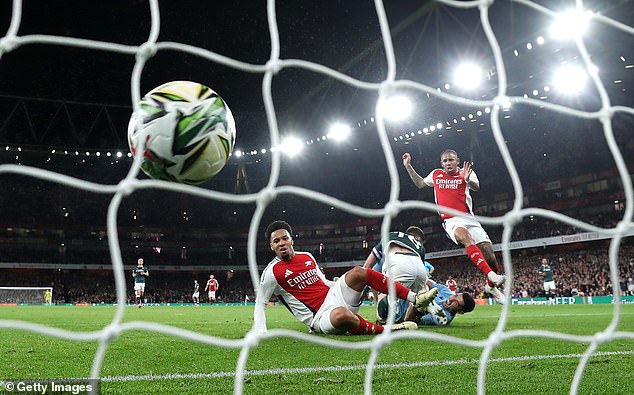 Nwaneri pictured (centre) immediately after scoring the first goal of his senior Arsenal career